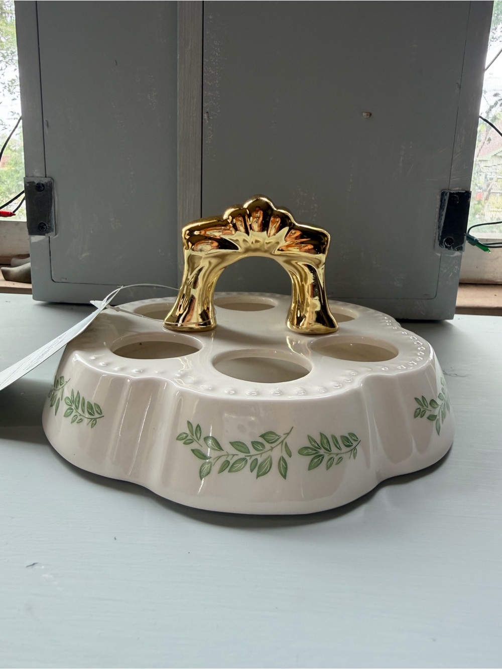 Ceramic Egg Holder with Gold Handle and Green Leaf Accent